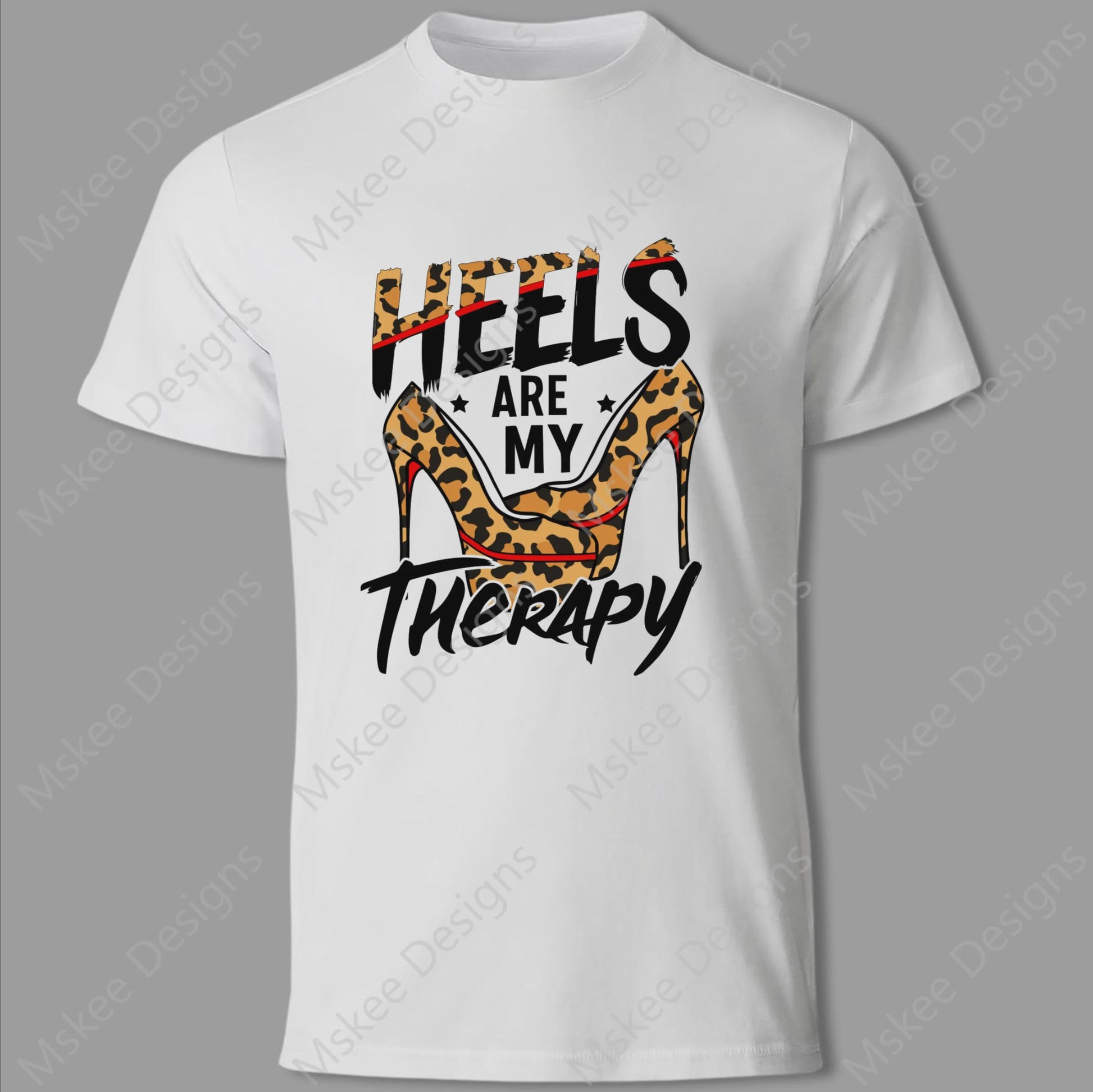White t-shirt with 'Heels are my Therapy' design featuring a leopard print high heel on a gray background.
