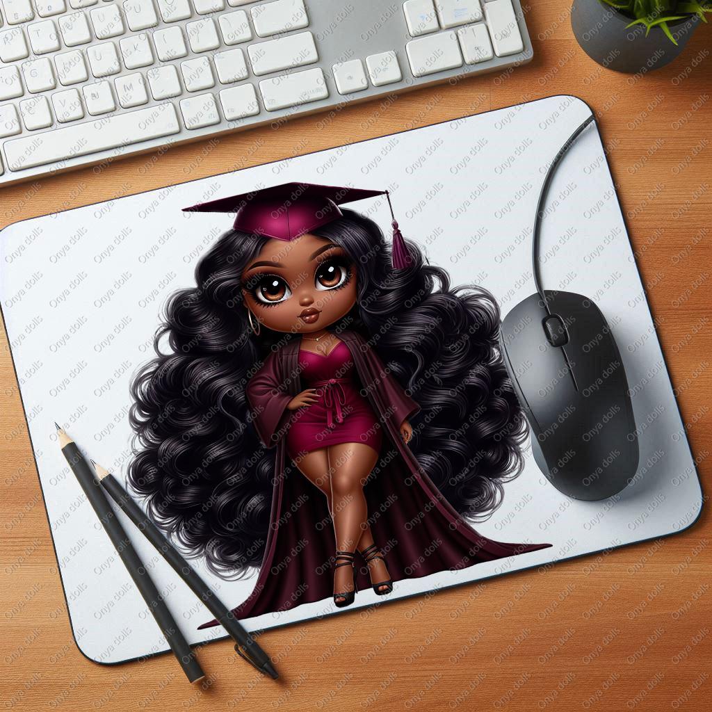 Mouse pad with a graduation-themed design on a desk with a keyboard and mouse.
