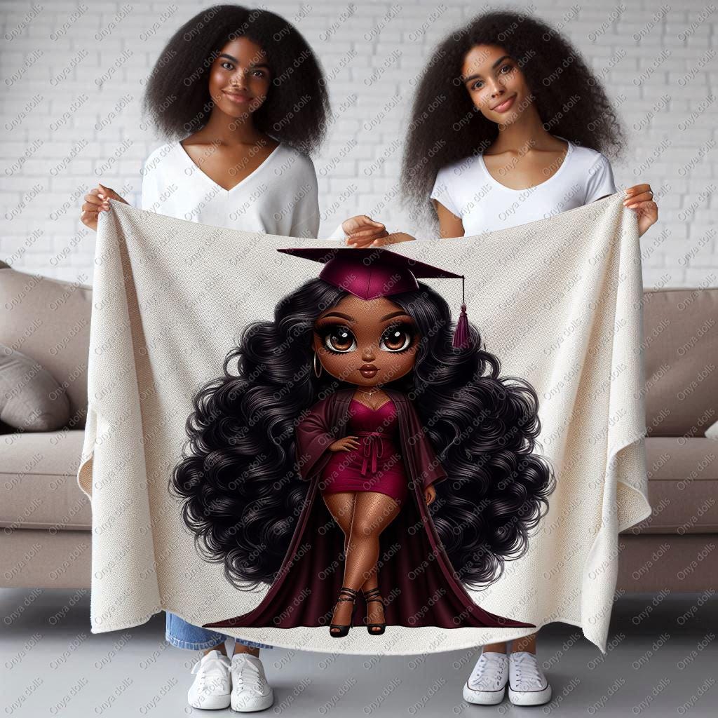 Two women holding a blanket with a graduation-themed design of a girl with long hair.