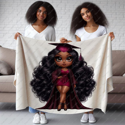 Two women holding a blanket with a graduation-themed design of a girl with long hair.