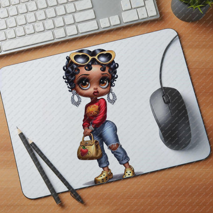 Mouse pad with a cartoon character on a desk with a keyboard and mouse.