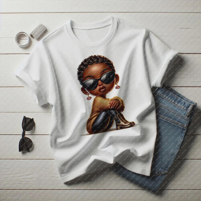 White t-shirt with a graphic of a child wearing sunglasses, accompanied by sunglasses and jeans on a wooden surface.